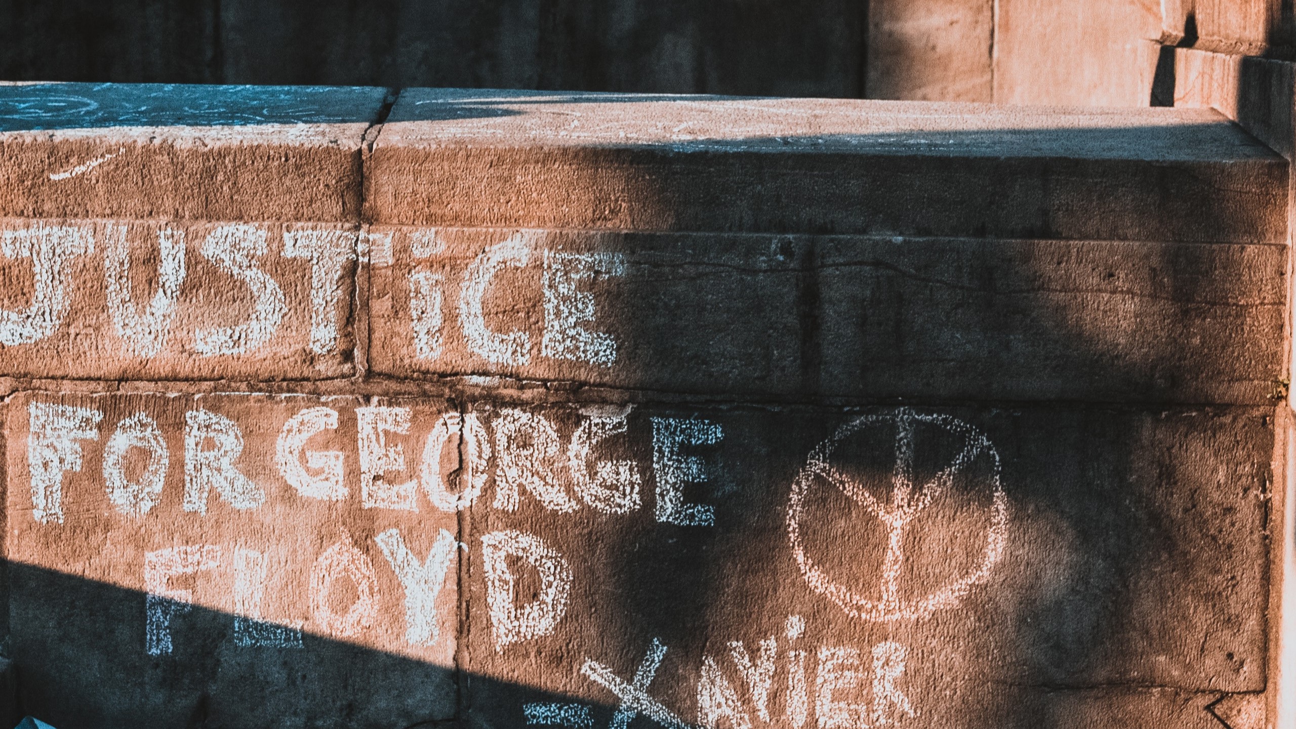 Photo by Kelly : https://www.pexels.com/photo/anonymous-black-woman-on-fence-with-inscriptions-near-stairs-4686576/